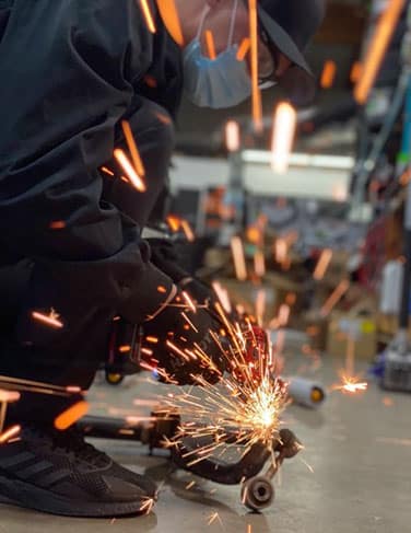 503 Motors employee using a grinder